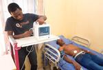 Oluwasoga Oni of MDaaS using medical equipment.
