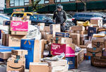 A curbside full of packages from vendors such as Amazon, Walmart, Blue Apron, and others