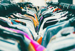 Two clothing racks crowded with shirts