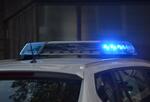 Police vehicle with blue emergency light turned on