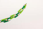 line of green pencils curving up and to the right