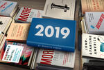 books stacked horizontally on a table