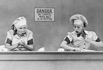 Still of Lucy and Ethel working at the candy factory from I Love Lucy