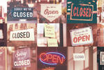 Collage of open and closed signs on businesses