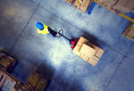 a warehouse worker pulls a wheeled pallet of boxes through a corridor
