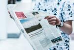 Person holding the politics section of a newspaper. Research finds variations of voters’ knowledge of political news across age, gender, race and socioeconomic status.