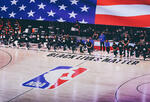 The Miami Heat and Milwaukee Bucks take a knee during the National Anthem prior to Game One of the Eastern Conference Second Round during the 2020 NBA Playoffs at the Field House at ESPN Wide World Of Sports Complex on August 31, 2020 in Lake Buena Vista, Florida.
