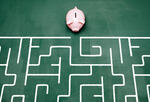 piggybank navigates a maze, meant to symbolize financial decision-making