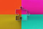 A puzzle piece on top of four quadrants filled with different colors