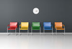 An illustration of five colorful chairs against a wall with a standard clock on the wall above them.