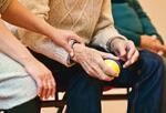Person holding an elderly person's hand