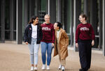 4 students from SWIM club walking close together 