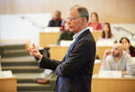 Professor Thomas Malone explaining something at the front of a classroom