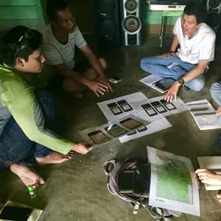 Illustrating and discussing market design ideas with market participants in rural Indonesia.